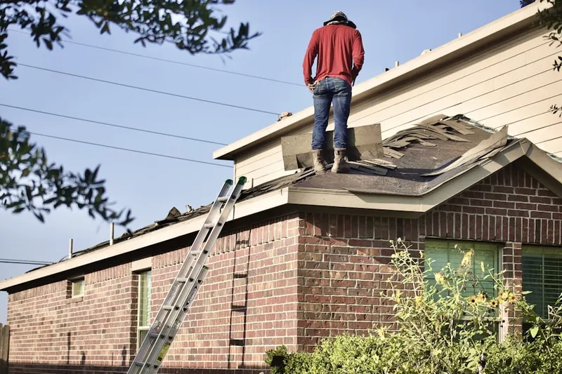 Professional roofer working on a residential roof in Camas